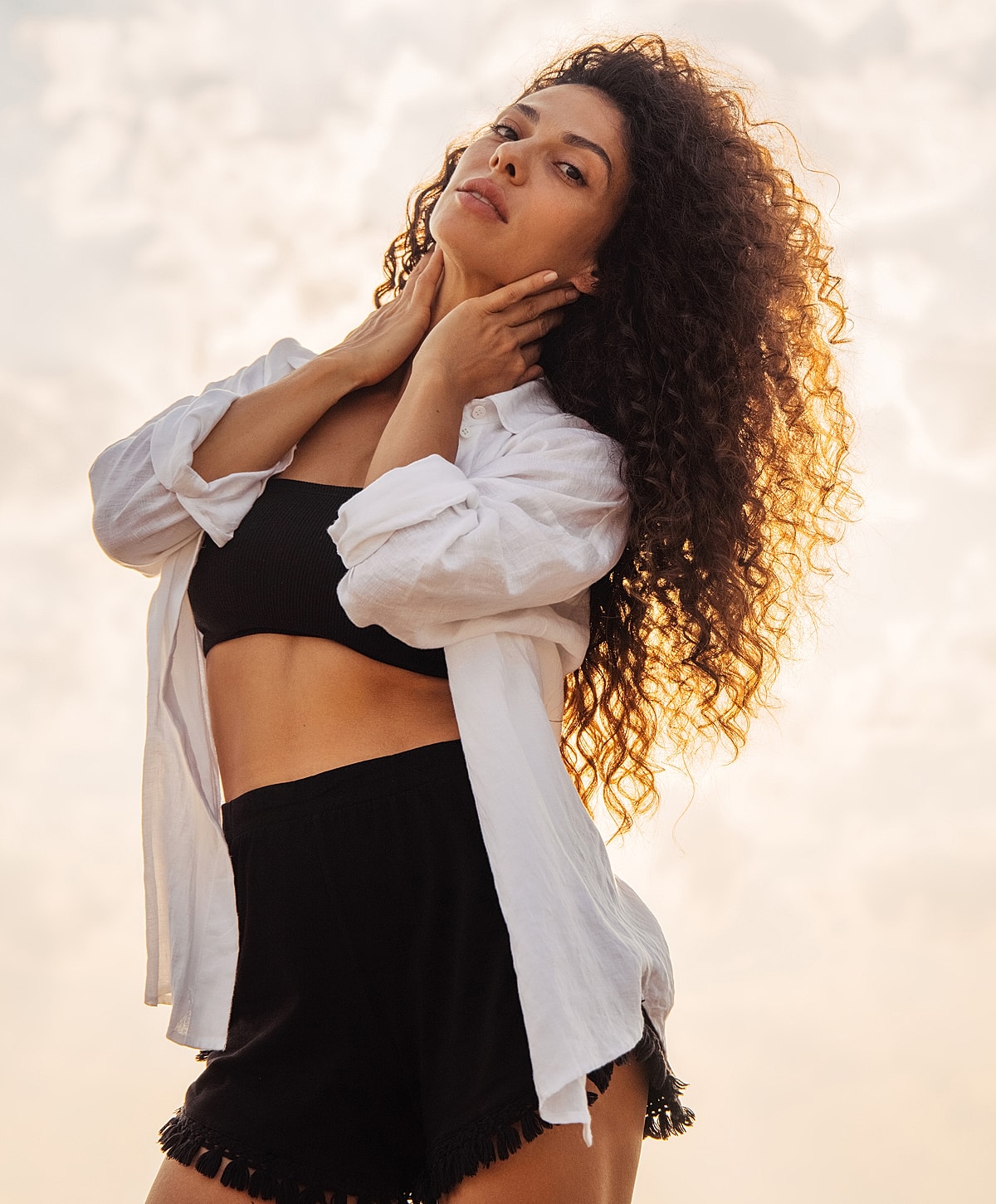 panniculectomy patient model with curly hair in sunlit outdoor setting.