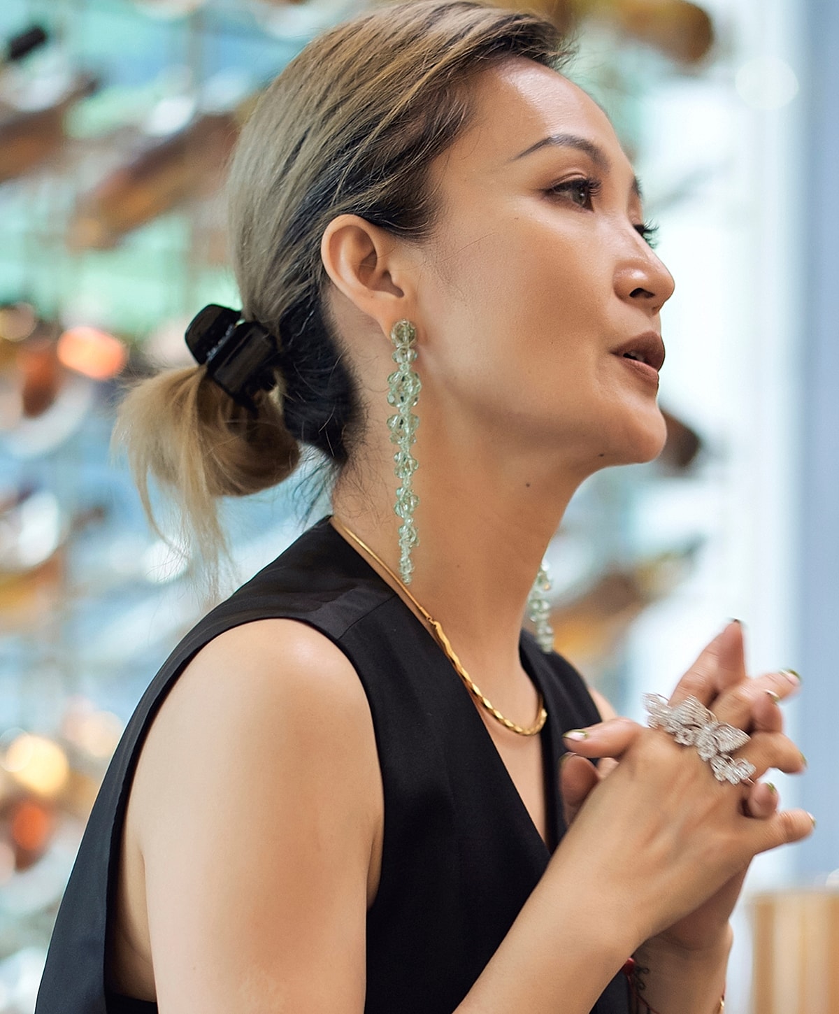 neck lift patient model with stylish jewelry and hairstyle.