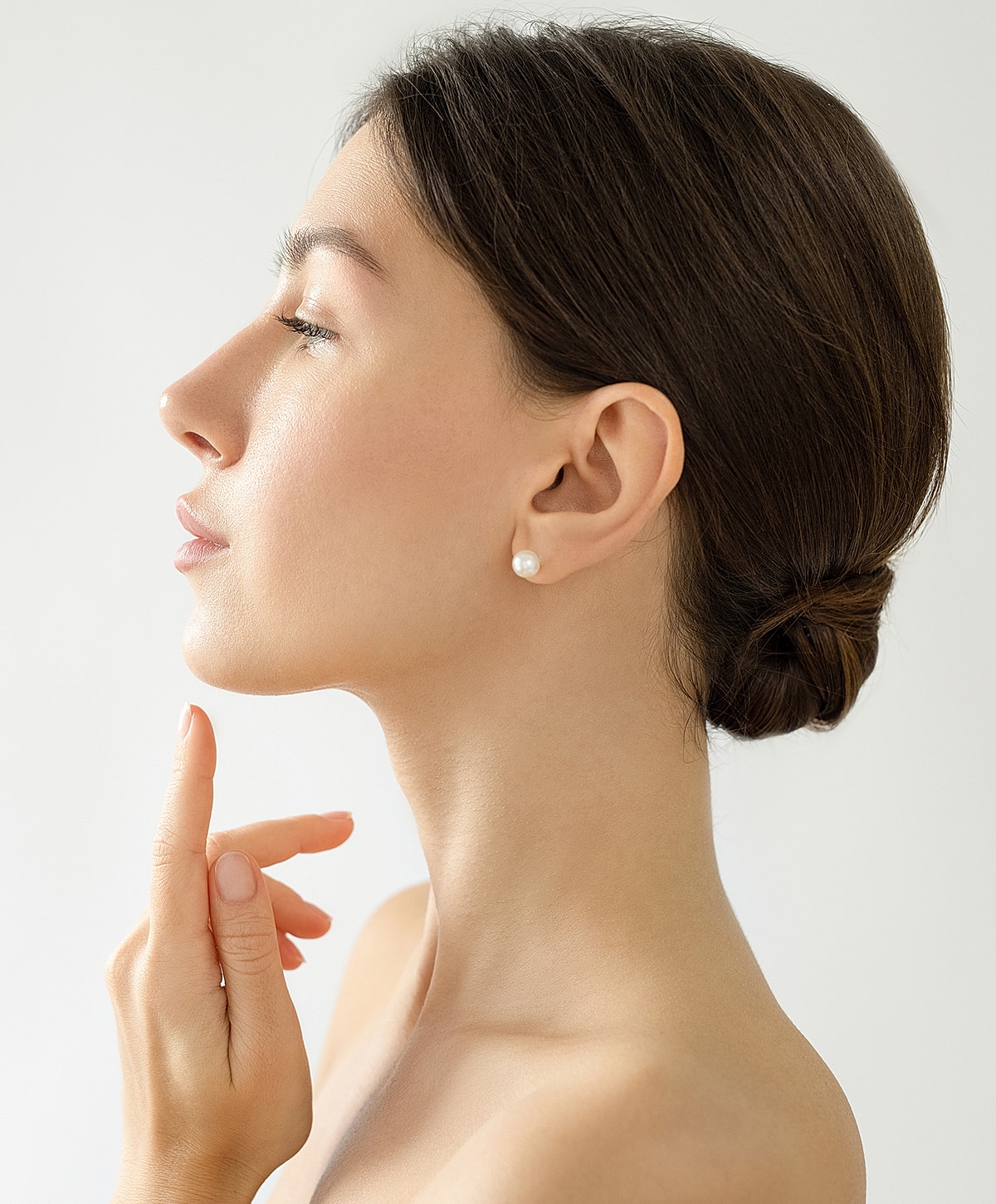 Profile of a otoplasty patient model with elegant hairstyle.